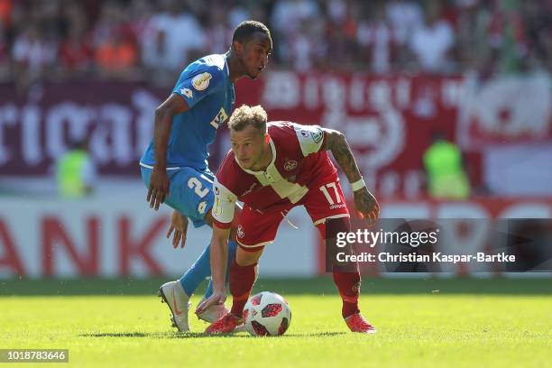 Christoph Hemlein of Kaiserslautern challenges Joshua Brenet of Hoffenheim during the first round DFB Cup match between 1. FC Kaiserslautern and TSG...