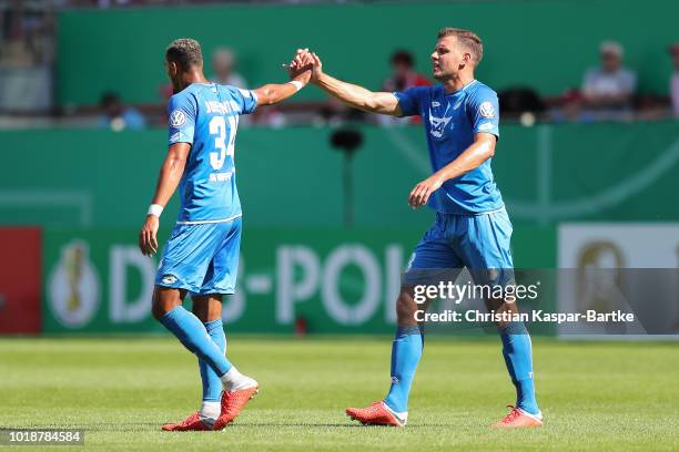 Joelinton of Hoffenheim celebrates the third goal with his teammate Adam Szalai of Hoffenheim during the first round DFB Cup match between 1. FC...