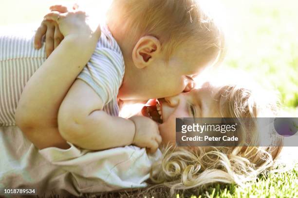 baby and sister playing on grass - siblings baby stock pictures, royalty-free photos & images