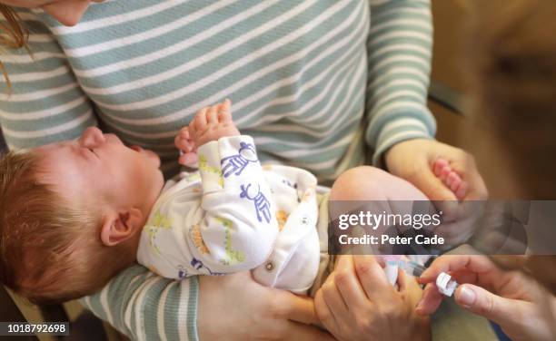 baby boy having injection into leg - children vaccination stock pictures, royalty-free photos & images