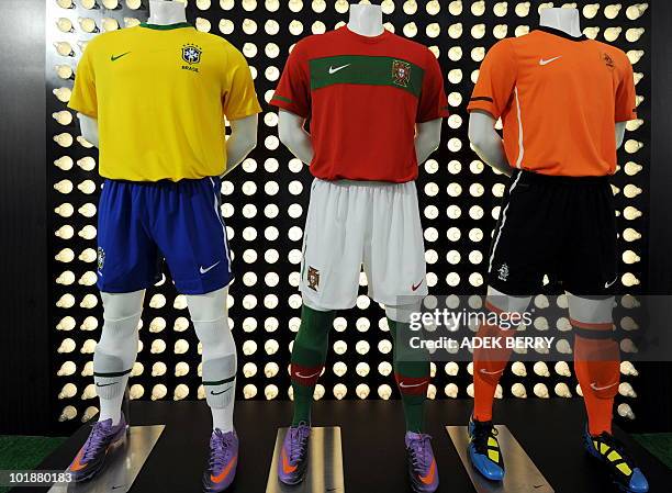 An art instalation made from plastic bottles is behind the football jerseys of the national team's of Brazil , Portugal and the Netherlands for the...