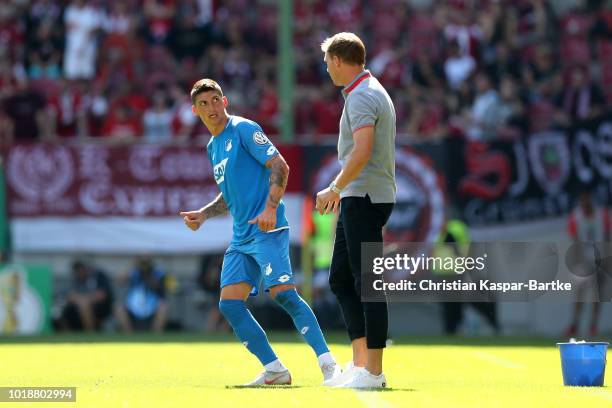 Head coach Julian Nagelsmann of Hoffenheim gives informations to Steven Zuber of Hoffenheim during the first round DFB Cup match between 1. FC...