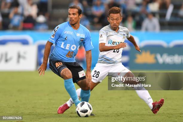 Leandro Domingues of Yokohama FC and Hideo Tanaka of Kamatamare Sanuki compete for the ball during the J.League J2 match between Yokohama FC and...