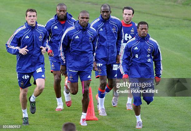 France's Sebastien Squillaci, William Gallas, Eric Abidal, Alou Diarra, Mathieu Valbuena and Patrice Evra run during a training session at the Fields...