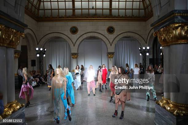 Models walk the runway at the Anne Karine Thorbjornsen show during Oslo Runway SS19 at Bankplassen 4 on August 14, 2018 in Oslo, Norway.