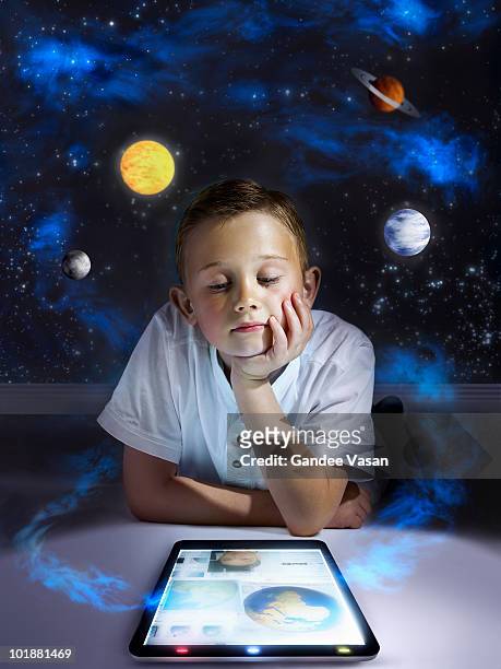 boy learning from tablet computer - all shirts stock-fotos und bilder