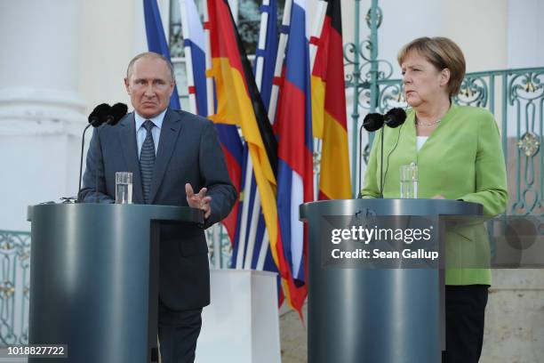 German Chancellor Angela Merkel and Russian President Vladimir Putin give statements to the media prior to talks at Schloss Meseberg palace, the...