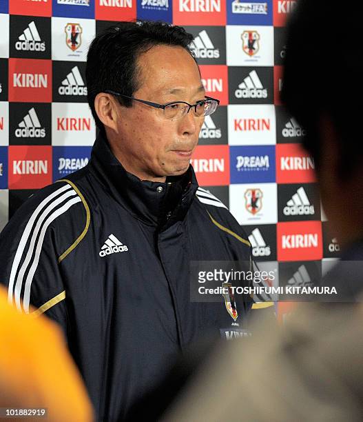Japan's head coach Takeshi Okada answers a question during a press conference at Japan's media centre, beside the Outeniqua Stadium, following their...