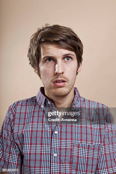 portrait of a man looking confused, studio shot - smart studio shot stockfoto's en -beelden