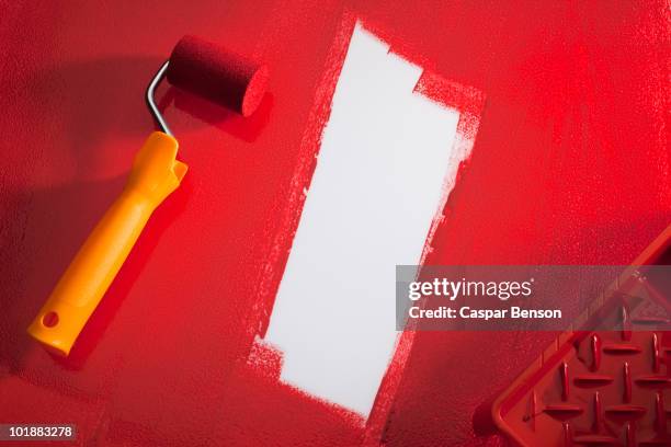 a paint roller with red paint - paint roller tray stock pictures, royalty-free photos & images