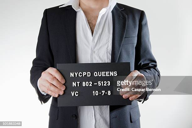 midsection of a man posing for a mug shot - mug shot stock pictures, royalty-free photos & images