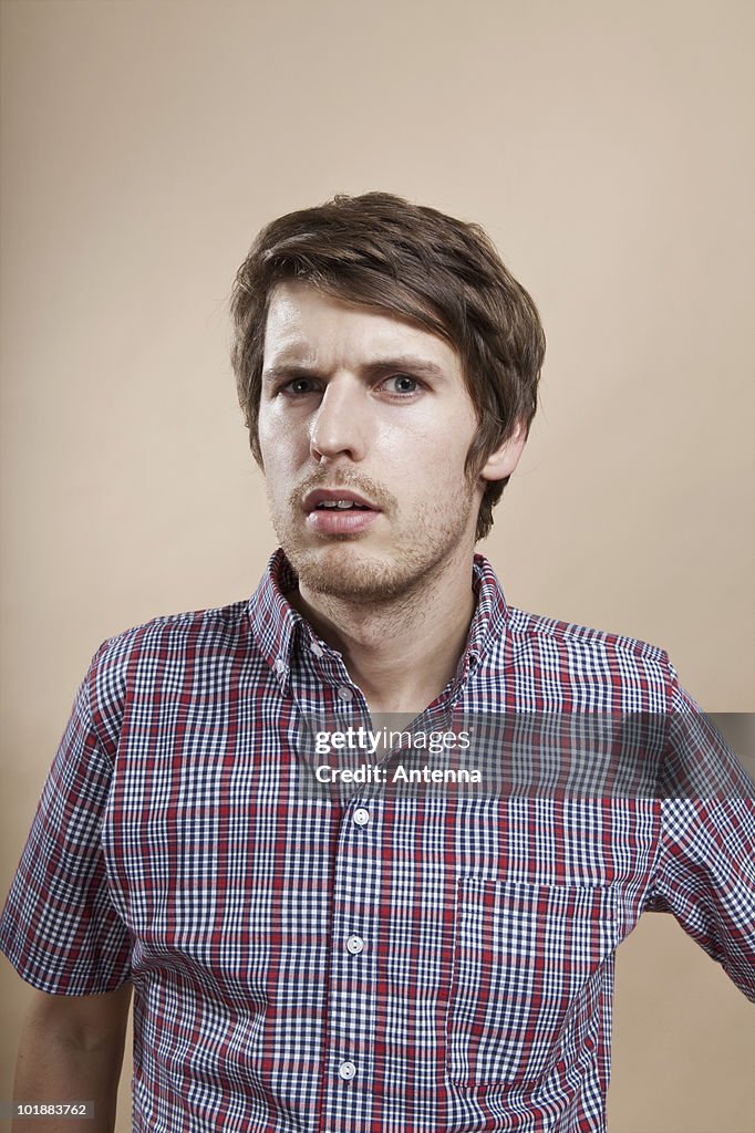 Portrait of a man looking confused, studio shot