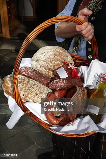 a woman holding a basket of sausages and bread, focus on basket, carinthia, austria - gift hamper imagens e fotografias de stock