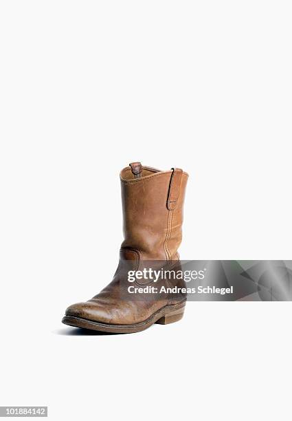 a single worn cowboy boot - cowboystövlar bildbanksfoton och bilder