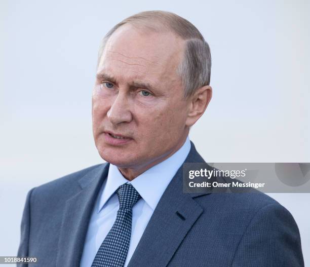 Russian President Vladimir Putin speaks during a joint press statement with German Chancellor Angela Merkel prior to their meeting at Schloss...