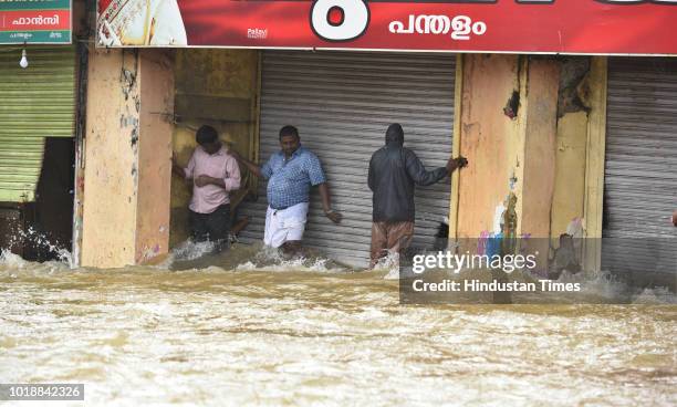 People stranded because of flood water at Panadala, on August 18, 2018 in district Pathanamthitta, India. The flooding, described by the chief...