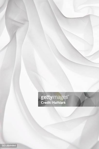 detail of folded white fabric on a light box - translucent stock pictures, royalty-free photos & images