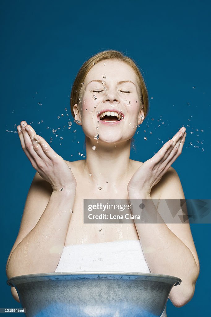 A woman washing her face