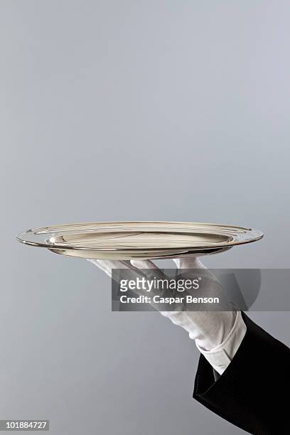 detail of a butler holding a sliver platter - tray fotografías e imágenes de stock