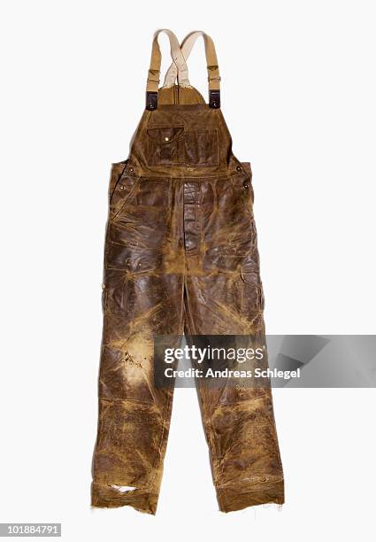 a pair of extremely worn overalls - dungarees stock-fotos und bilder