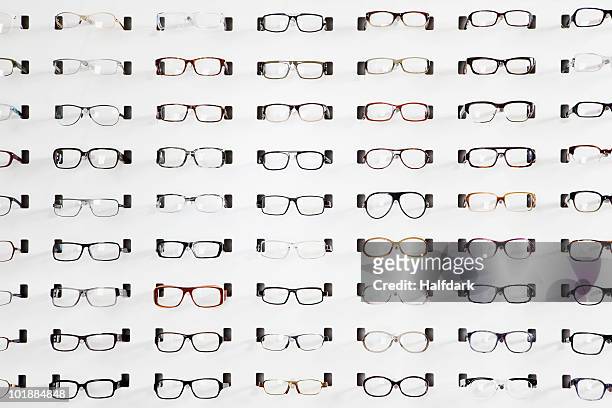 an eyeglasses display in an eyewear store - skåp med glasdörrar bildbanksfoton och bilder
