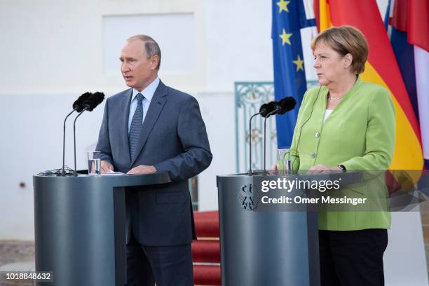 German Chancellor Angela Merkel and Russian President Vladimir Putin deliver a joint press statement prior to their meeting at Schloss Meseberg...