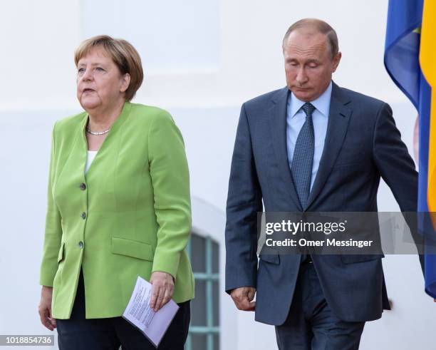 German Chancellor Angela Merkel and Russian President Vladimir Putin arrive to deliver a joint press statement prior to their meeting at Schloss...