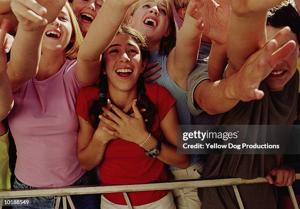 elated teenage girls (14-16) reaching out toward star - crowd excitement stock pictures, royalty-free photos & images