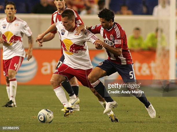 Seth Stammler of the New York Red Bulls and Marcelo Saragosa of Chivas USA battle for position on a loose ball during their game at Red Bull Arena on...