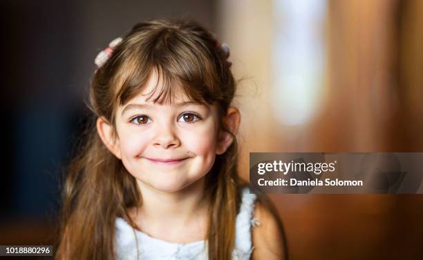 cute little girl (3-4) smiling and looking at camera - cute girl portrait stock pictures, royalty-free photos & images