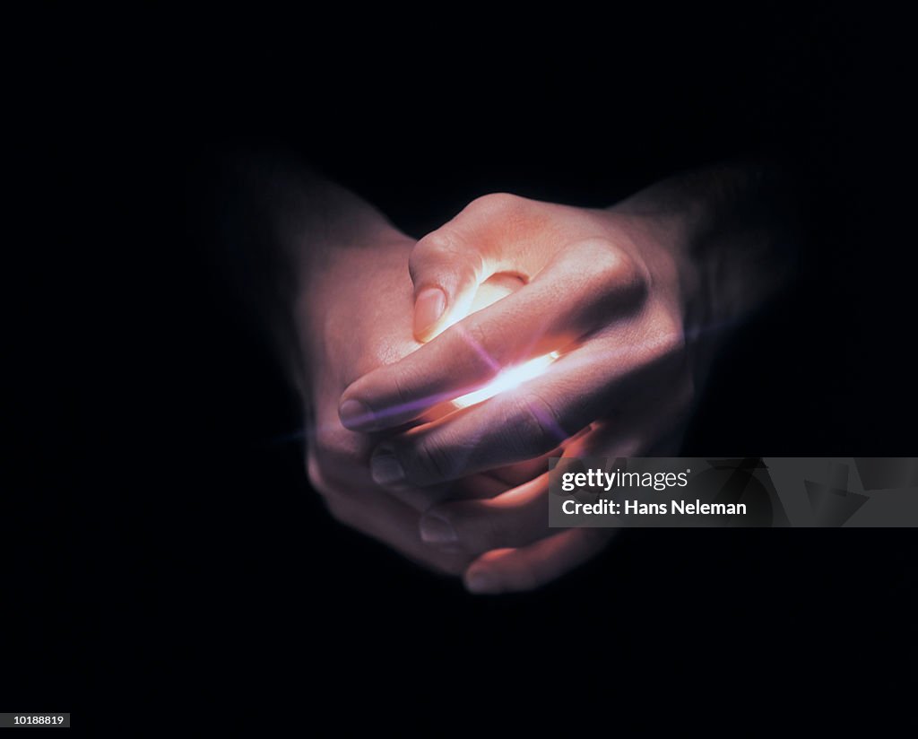 Hands covering white light