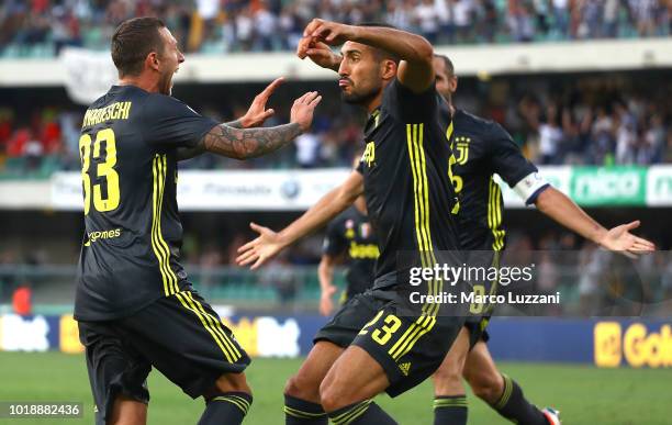 Federico Bernardeschi of Juventus celebrates his goal with his team-mate Emre Can during the serie A match between Chievo Verona and Juventus at...