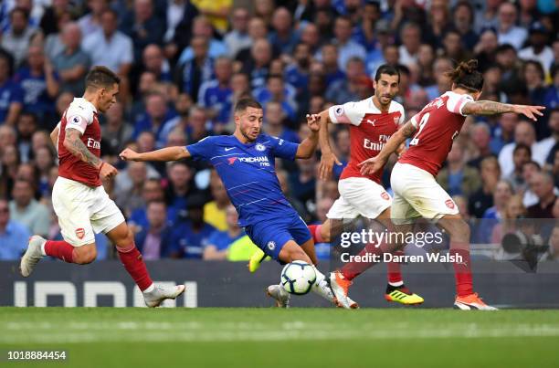 Eden Hazard of Chelsea turns with the ball under pressure from Lucas Torreira, Henrikh Mkhitaryan, Hector Bellerin of Arsenal during the Premier...