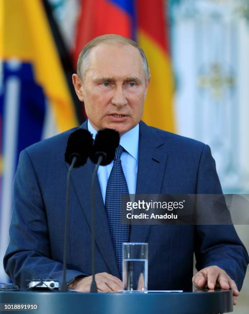Russian President Vladimir Putin and German Chancellor Angela Merkel hold a press conference ahead of their meeting at Meseberg Palace in Gransee...