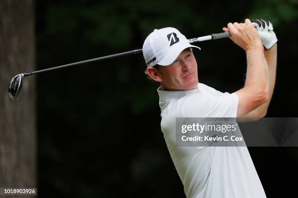 Brandt Snedeker plays his shot from the second tee during the third round of the Wyndham Championship at Sedgefield Country Club on August 18, 2018...