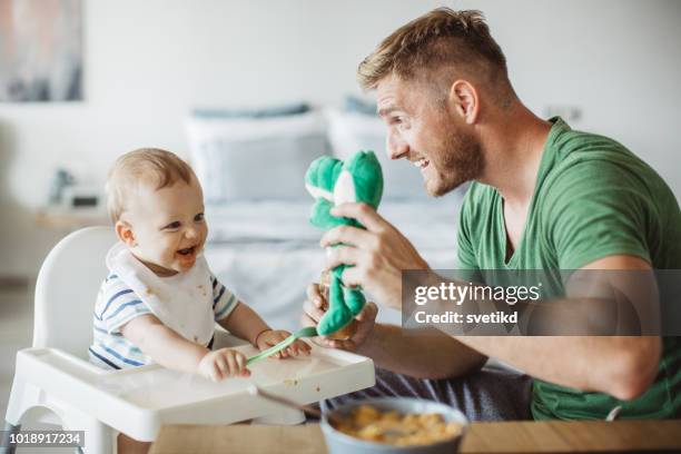 you need to eat to get big and strong - baby eating toy stock pictures, royalty-free photos & images