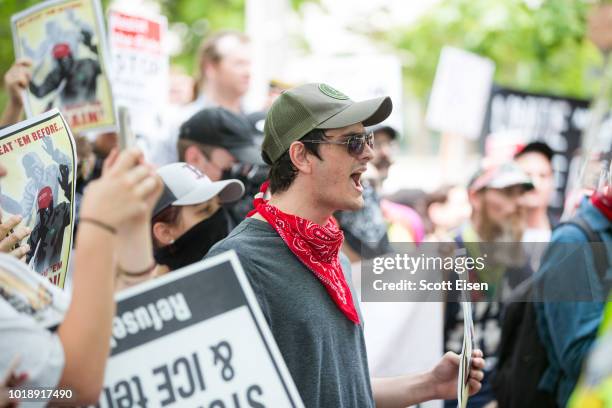 Counter protesters march and hold up signs during a rally organized by Boston Free Speech on August 18, 2018 in Boston, Massachusetts. The rally,...