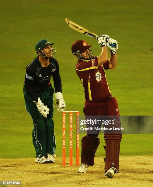 Mal Loye of Northamptonshire hits a six, as Paul Nikon of Leicestershire looks on during the Friends Provident T20 match between Northamptonshire and...