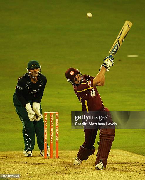 Mal Loye of Northamptonshire hits the ball towards the boundary, as Paul Nikon of Leicestershire looks on during the Friends Provident T20 match...