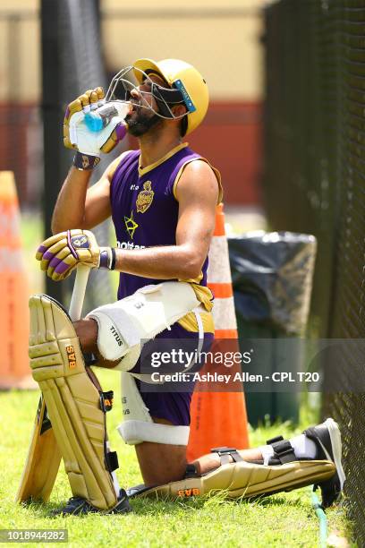 In this handout image provided by CPL T20, Hamza Tariq has a drink during a Trinbago Knight Riders nets and training session at Central Broward...