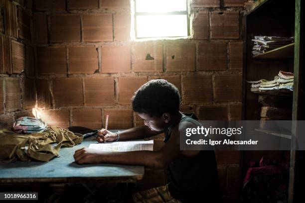 brazilian boy studying at home - slum children stock pictures, royalty-free photos & images