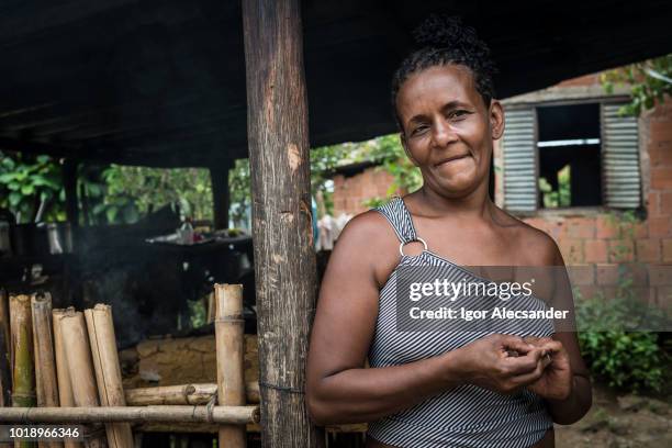 brazilian woman at her home in the kitchen of a wood stove - starving woman stock pictures, royalty-free photos & images