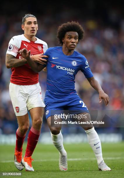 Willian of Chelsea is held by Hector Bellerin of Arsenal during the Premier League match between Chelsea FC and Arsenal FC at Stamford Bridge on...