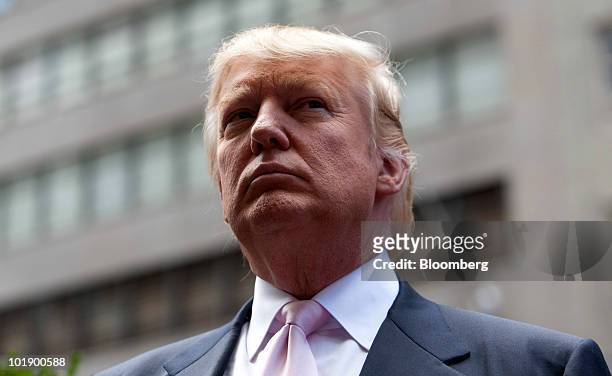 Real estate investor Donald Trump listens during a ceremony outside Trump Tower in New York, U.S., on Tuesday, June 8, 2010. Gray Line New York,...