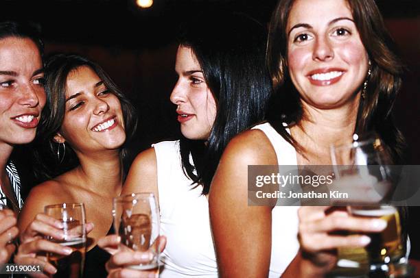 four young women having drinks in nightclub - girls night out stockfoto's en -beelden