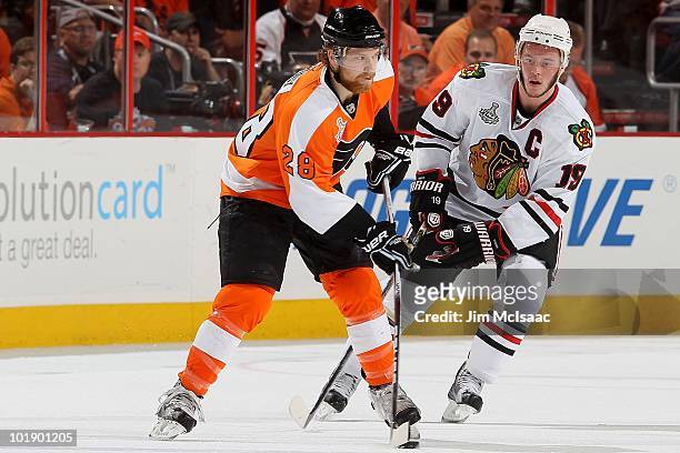 Claude Giroux of the Philadelphia Flyers handles the puck against Jonathan Toews of the Chicago Blackhawks in Game Four of the 2010 NHL Stanley Cup...