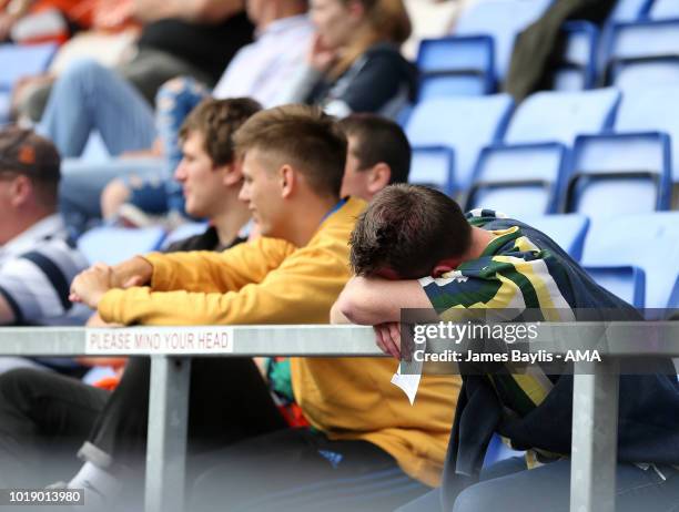 Blackpool supporter sleeps during the Sky Bet League One match between Shrewsbury Town and Blackpool at New Meadow on August 18, 2018 in Shrewsbury,...