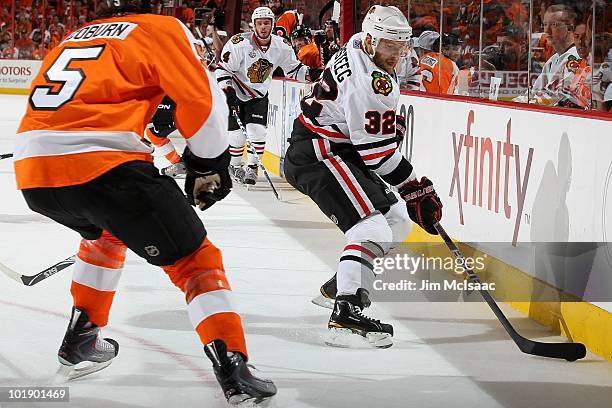 Kris Versteeg of the Chicago Blackhawks handles the puck against Braydon Coburn of the Philadelphia Flyers in Game Four of the 2010 NHL Stanley Cup...