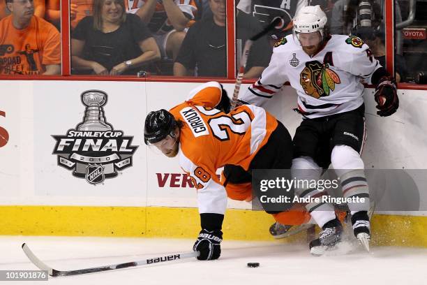 Duncan Keith of the Chicago Blackhawks fights for the puck against Claude Giroux of the Philadelphia Flyers in Game Four of the 2010 NHL Stanley Cup...