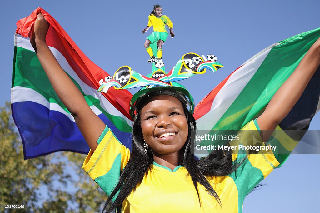 Soccer supporter waving flag, Johannesburg, South Africa